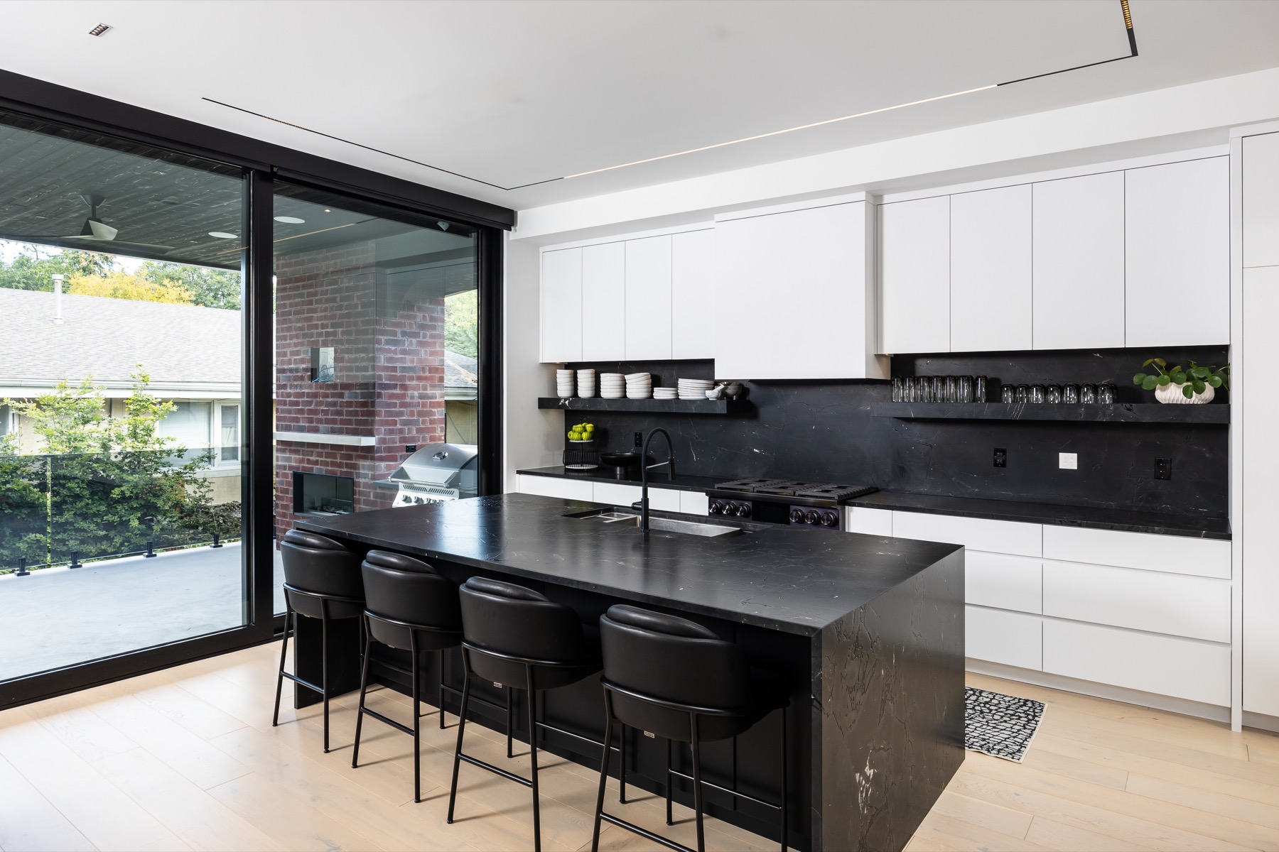 Kitchen with architectural linear ceiling lighting and illuminated cabinetry at Ashton Manor