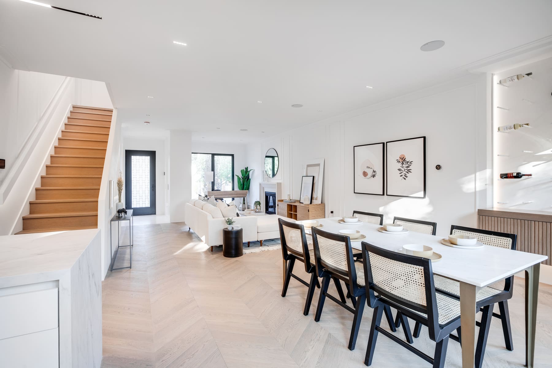 Bright dining and living room beside a timber stair